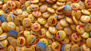 a pile of different emoji pins