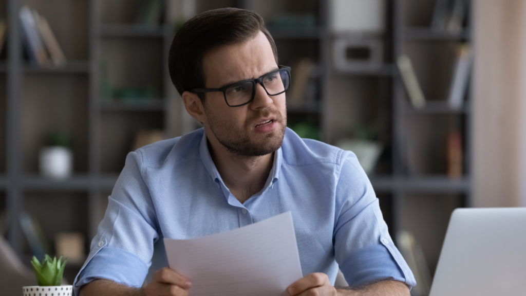 worried businessman reading a paper